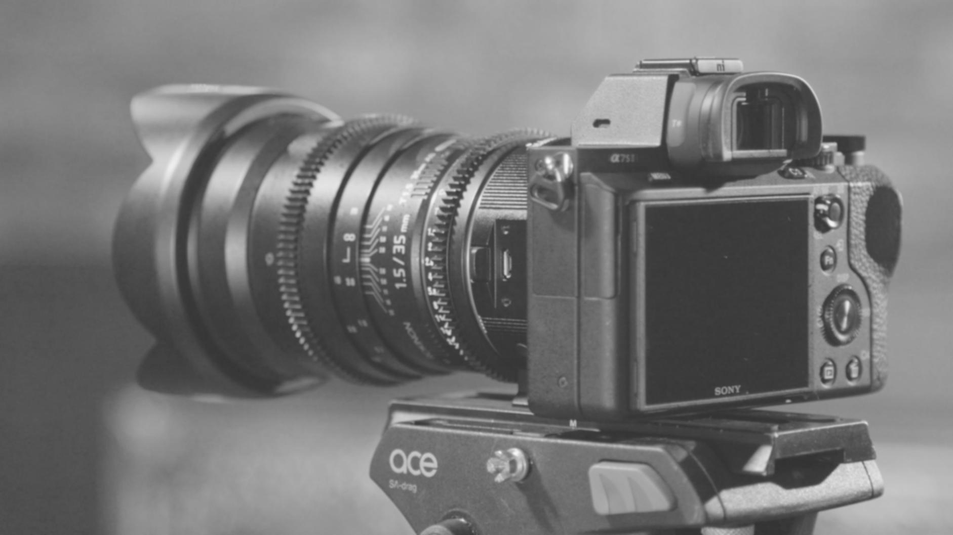 Professional video editing workspace showing multiple monitors with timeline sequences and color grading tools